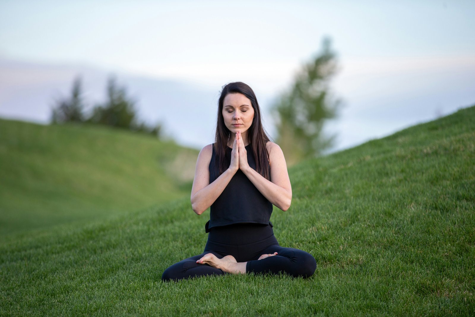 A woman in a hijab practising mindful yoga at home